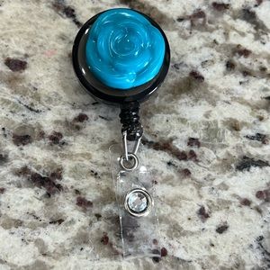 Blue teal flower diamond badge reel.